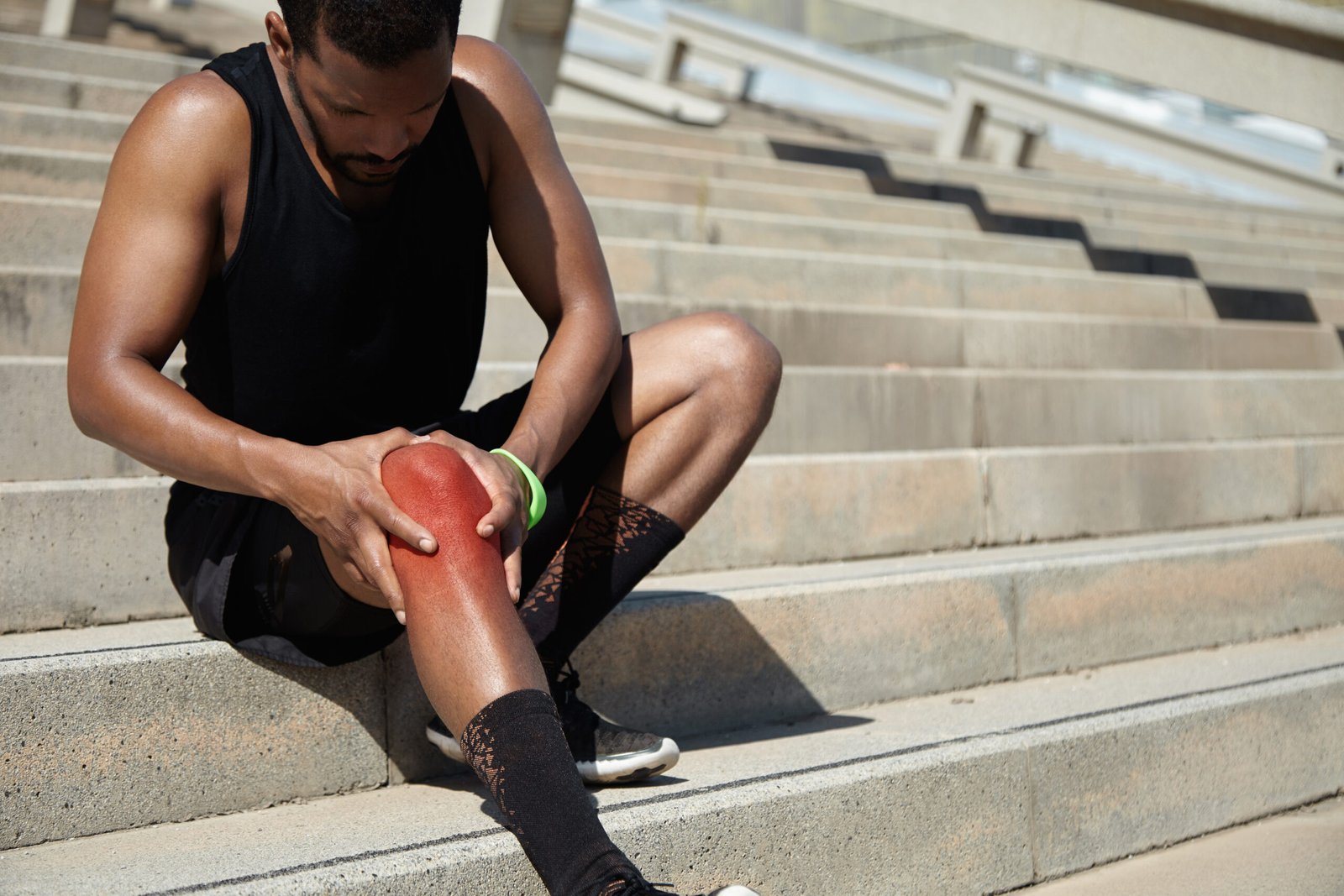 "Physiotherapist assisting osteoarthritis patient with knee strengthening exercises"